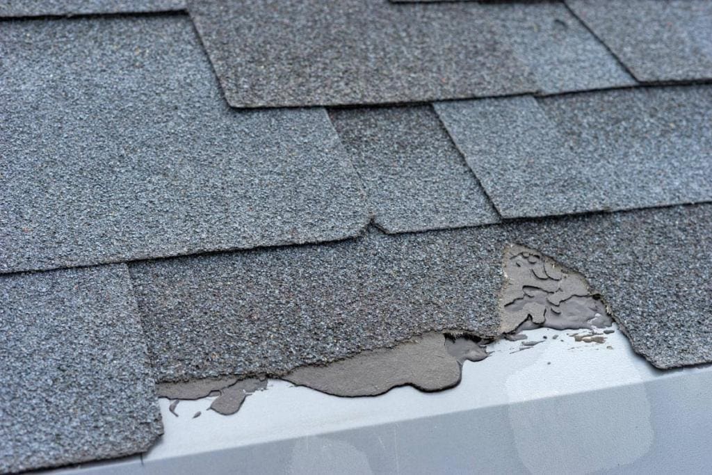 Broken Shingles on Roof As Warning Sign to Contact Daniel Hood Roofing for Roof Replacement in Knoxville, TN