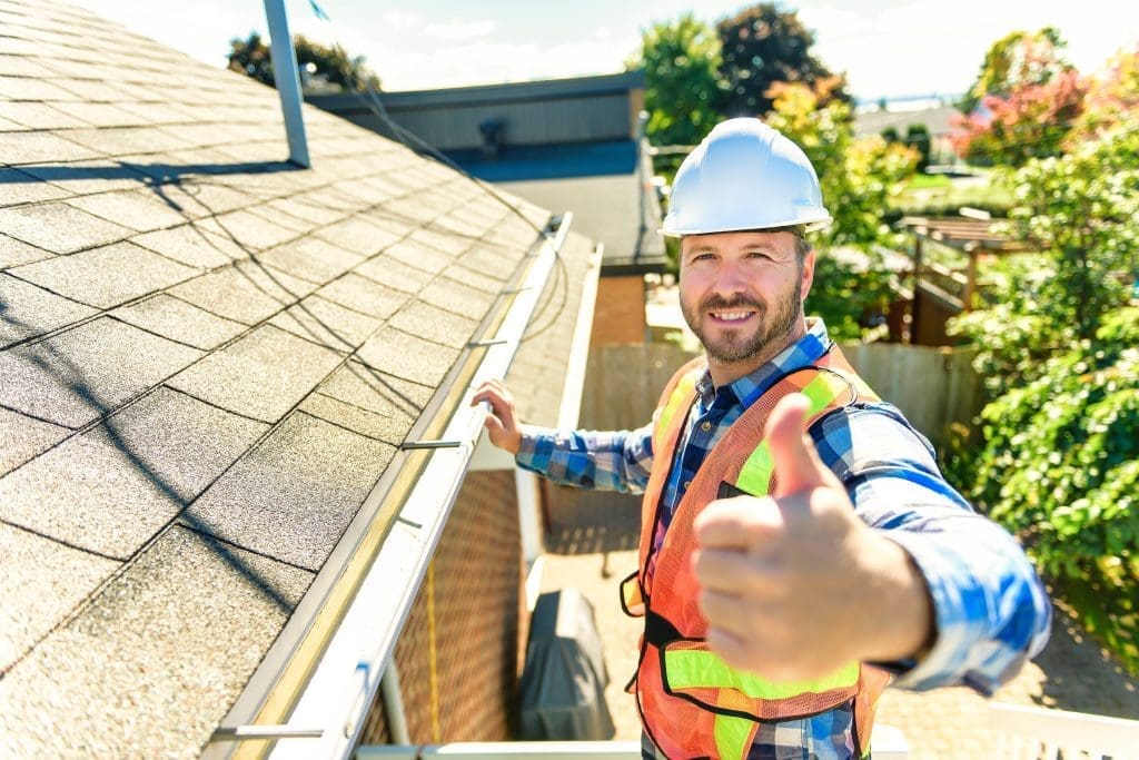 roofer giving thumbs up with a hard hat on