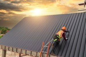 construction worker on metal roof - metal roofing company